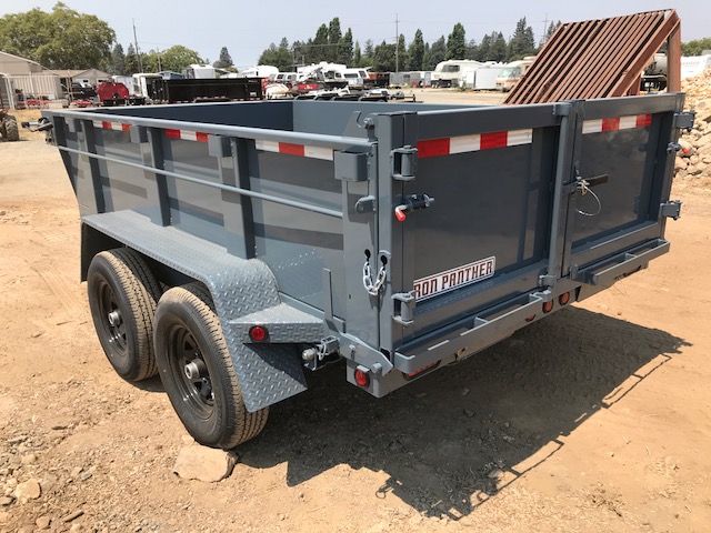 The Iron Panther dump trailer from behind at a worksite