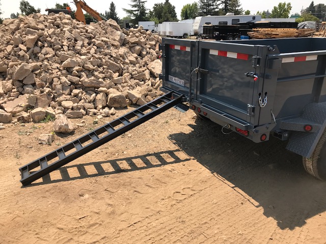 Iron Panther dump trailer with the under ramp deployed.