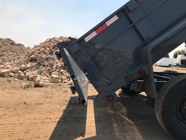 The Iron Panther dump trailer angled up with the spreader gate open