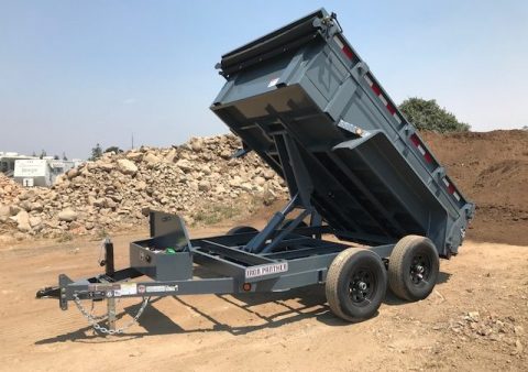 This is a dump trailer with a scissor lift available at Truck Tops USA in Santa Rosa.